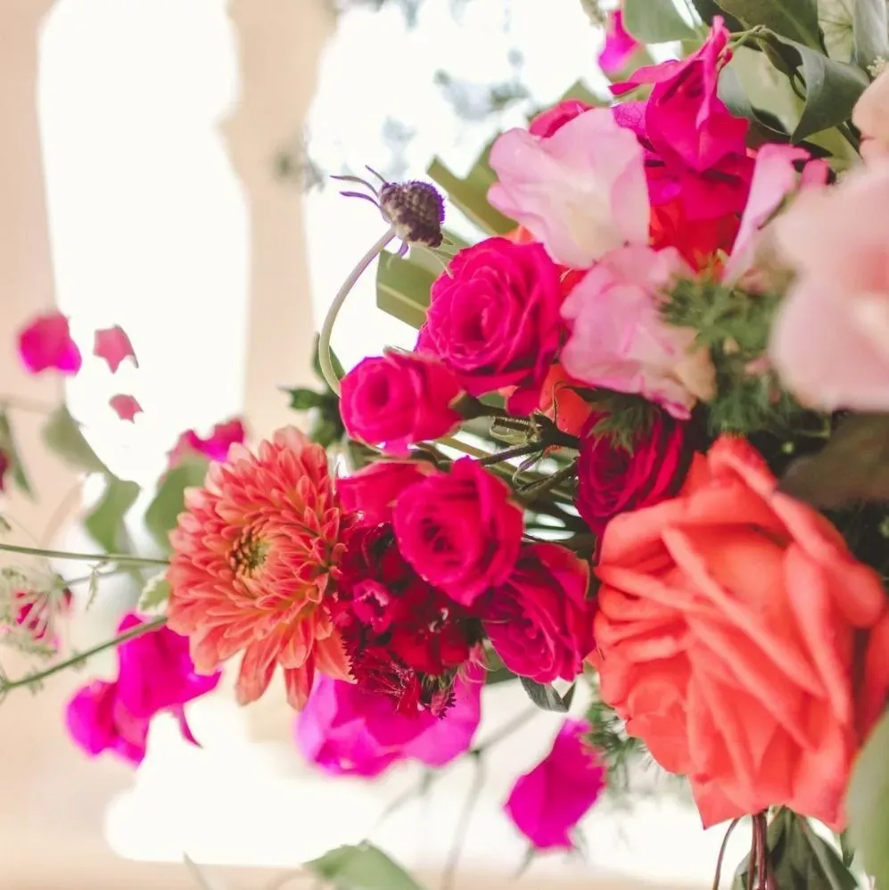 Colorful pink and coral centerpiece from Botanical Eden’s portfolio