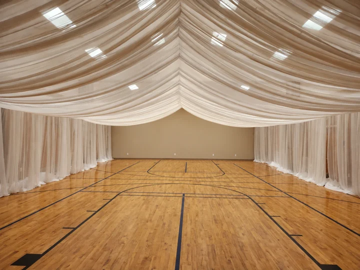 Edited BSS installation example showing white overhead canopy and both long side walls, with the far end wall bare and no decorative string lights.