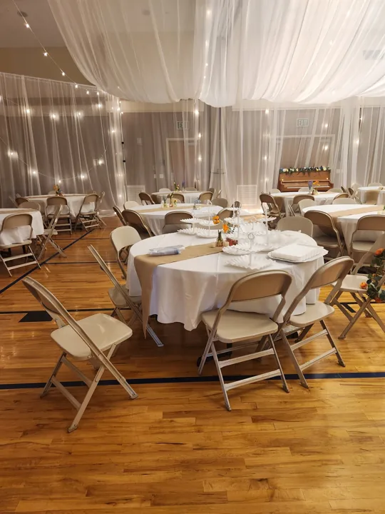 Round tables and floral centerpieces in the finished room.