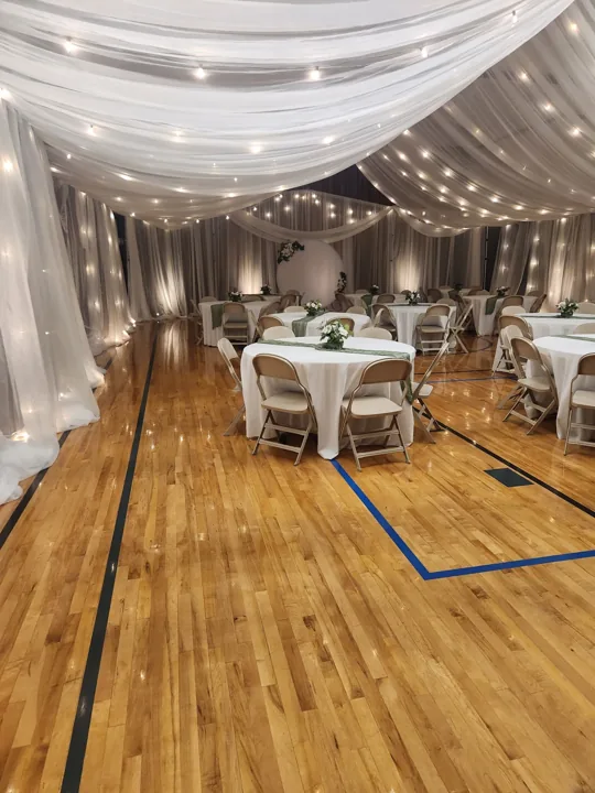 White draping and warm lights around the Boise reception.