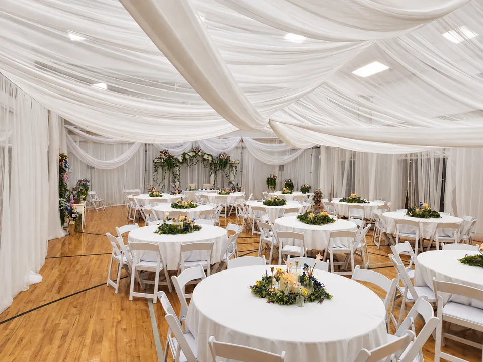 White canopy draping and floral reception tables in Meridian, Idaho